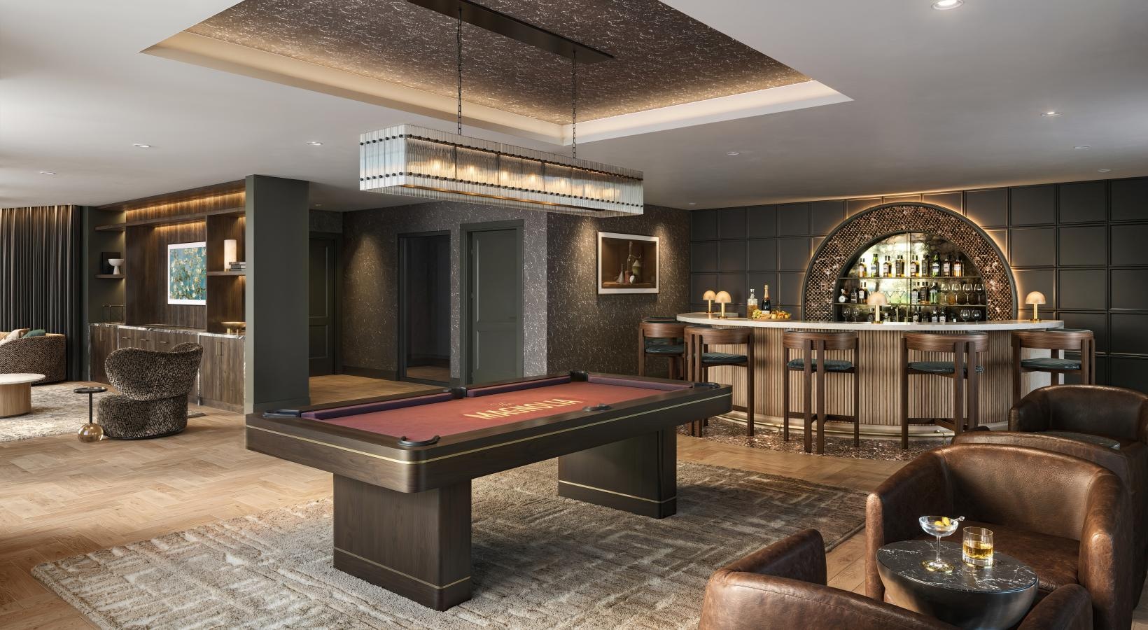a billiards room with a pool table, bar and lounge seating