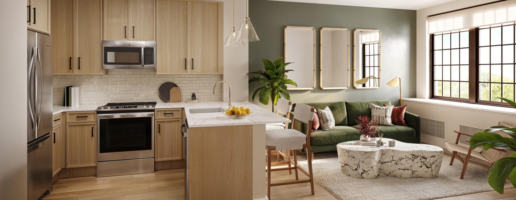 a kitchen with a large island and a spacious naturally-lit living area