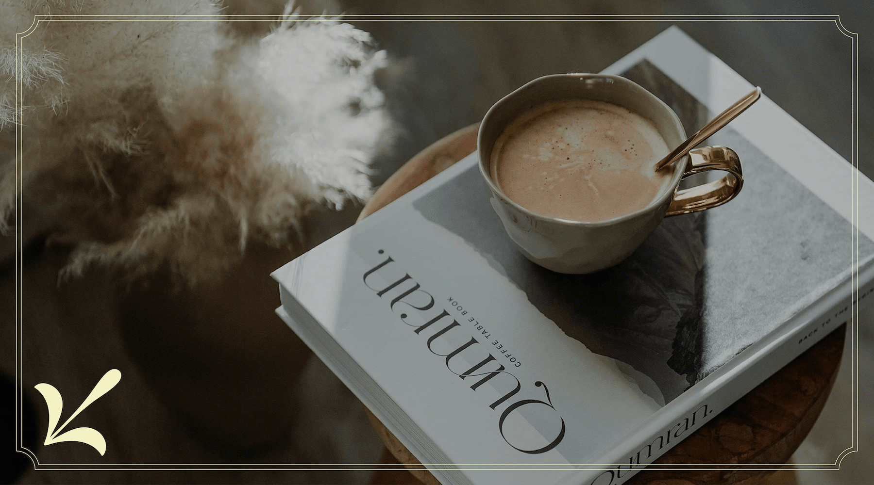 a cup of coffee on a book on a stool in a living room